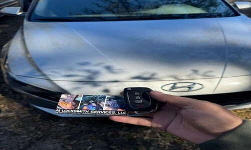 Person holding a car key fob with a photo of a person, representing remote key fob programming for automotive locksmith services.