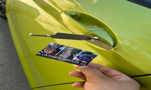 A person presents a business card beside a green car, emphasizing car lock repair service for automotive assistance.