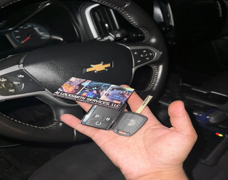 Individual displaying a business card near a green car, highlighting automotive locksmith service for car lock solutions.