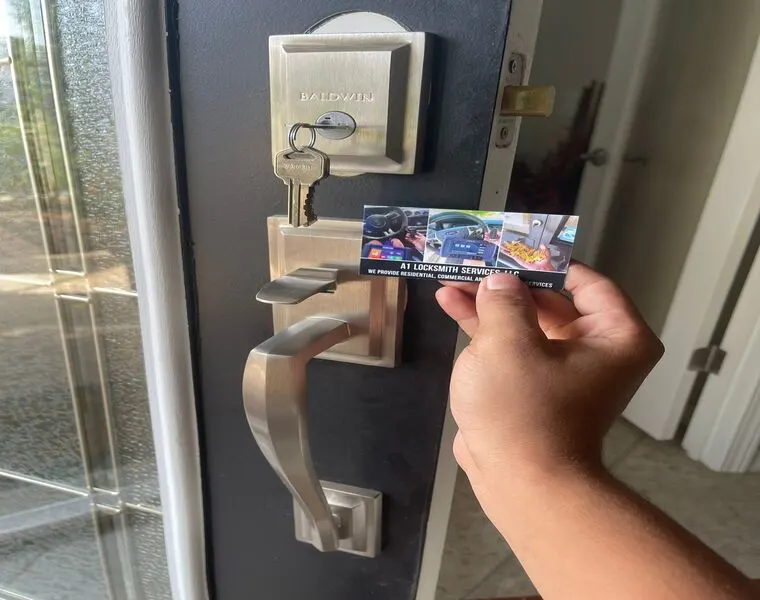 A person displaying a business card for Commercial Locksmith in front of a door, highlighting locksmith expertise and services.