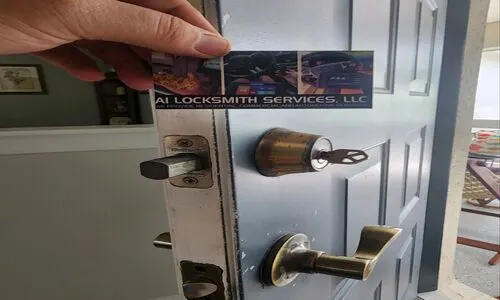 Close-up of a hand holding a business card with a lock design, symbolizing a Residential Locksmith service.