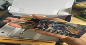 A hand holding a set of keys, a brass padlock, and a business card for A1 Locksmith Services, showcasing various locksmith services for residential, commercial, and automotive needs.