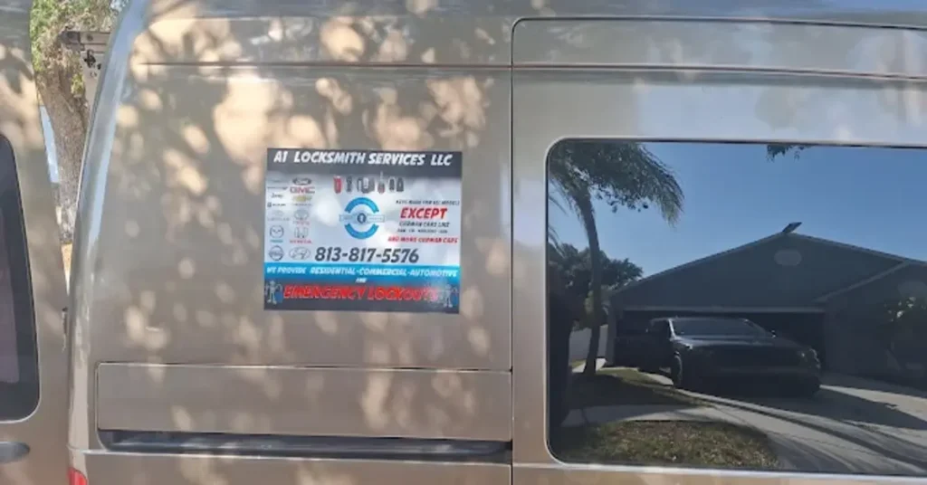 The side of a van displaying the logo and contact information for A1 Locksmith Services LLC, offering residential, commercial, automotive, and emergency lockout services. The van is parked outdoors with a clear view of the house in the background.