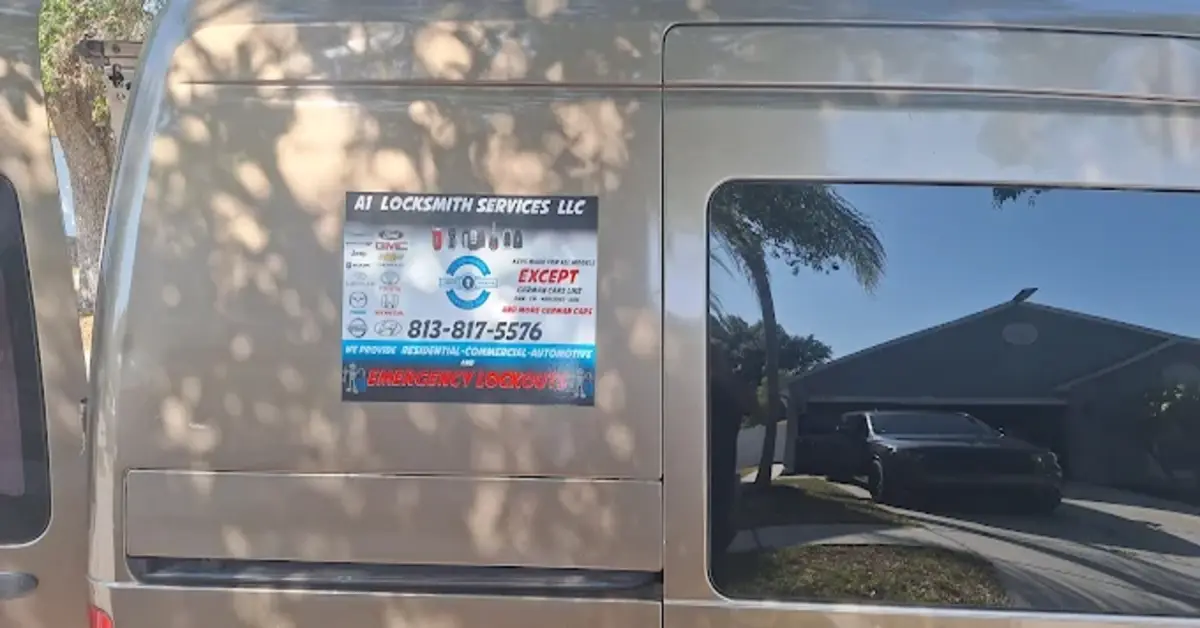 The side of a van displaying the logo and contact information for A1 Locksmith Services LLC, offering residential, commercial, automotive, and emergency lockout services. The van is parked outdoors with a clear view of the house in the background.