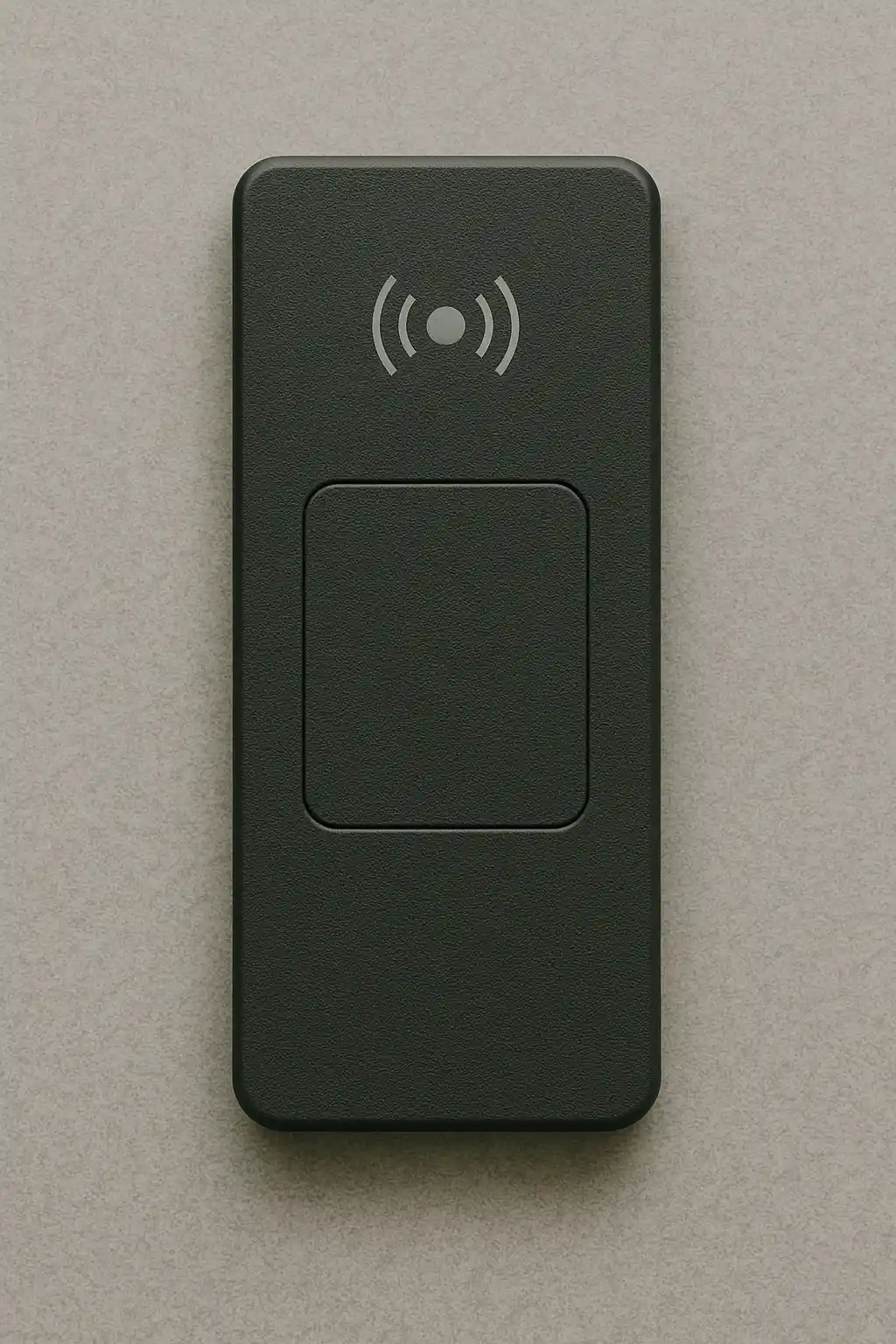 Hand holding a proximity card near a black proximity reader with a green light on a wall