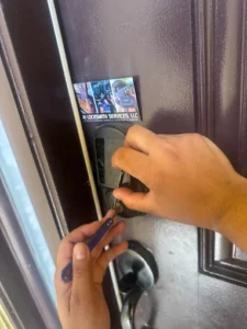A1 Locksmith Services LLC technician replaces a front door lock using professional tools, showcasing expert residential lock replacement service for homeowners.