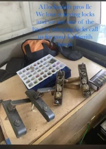 Locksmith tools, door lock hardware, and a pinning kit displayed on a workbench with an A1 Locksmith Services LLC label, representing professional residential lock installation service.