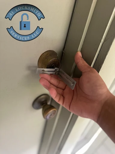 A1 Locksmith Services LLC technician uses a professional tool to fix a brass door lock, demonstrating expert commercial lock repair service for business properties.