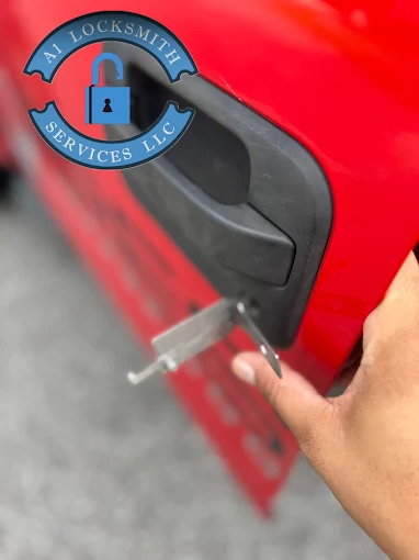 A1 Locksmith Services LLC technician uses a specialized tool on a red car door handle during a professional broken key extraction service.