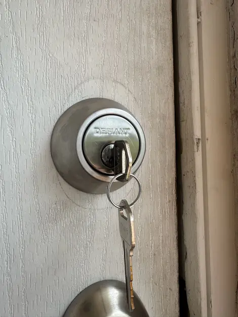 Newly installed residential door deadbolt with key inserted, representing secure home entry provided by a professional residential locksmith service.