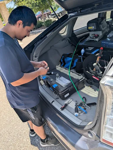 A1 Locksmith Services LLC technician works from the trunk of a vehicle with locksmith tools and key machines, showcasing professional automotive locksmith service.