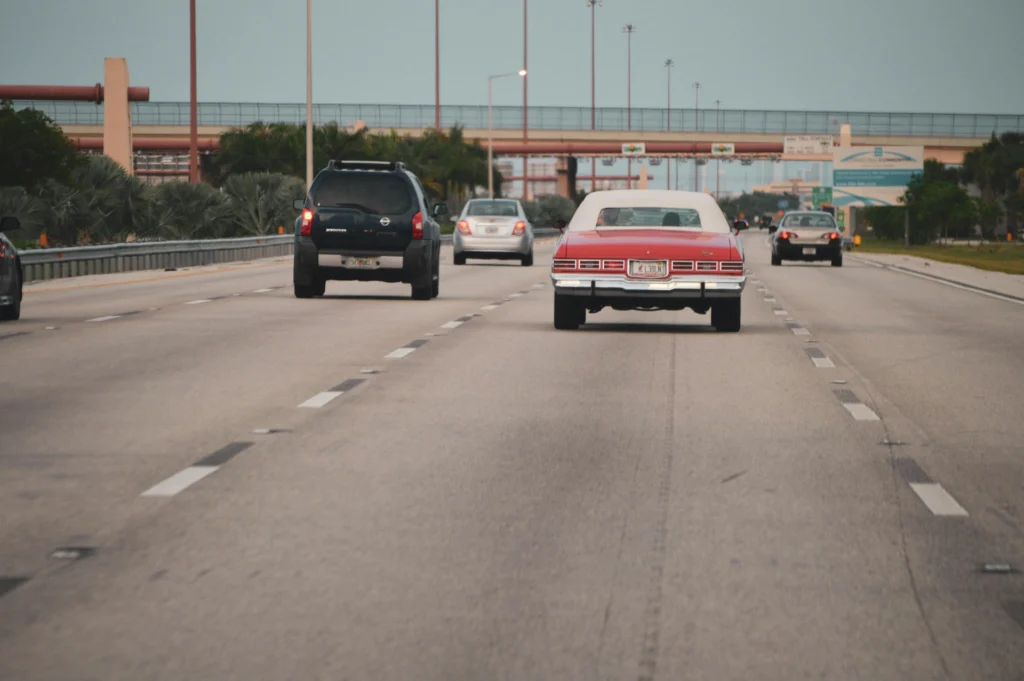 A car driving along a highway in Riverview, symbolizing the importance of security and protection, much like upgrading locks to safeguard your home.