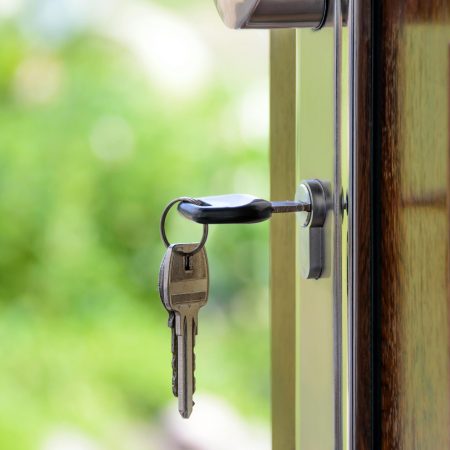 A key secured to a door handle, illustrating the theme of lock replacement and the importance of home security in Riverview.